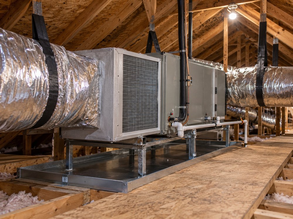 Illustrative HVAC scene: An air handler and flexible ductwork in a Georgia attic, with a condensate line and a secondary drain pan.